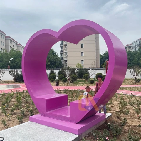 A purple heart-shaped seating feature in an outdoor garden.