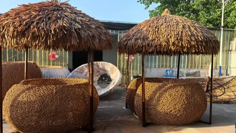Two finished woven seating sets with thatched-style canopies.